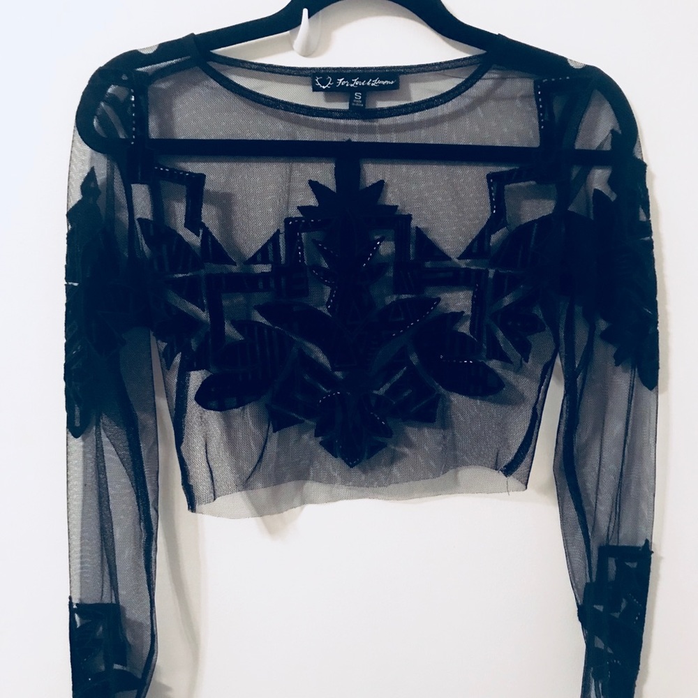 Black mesh top with velvet details and beading.